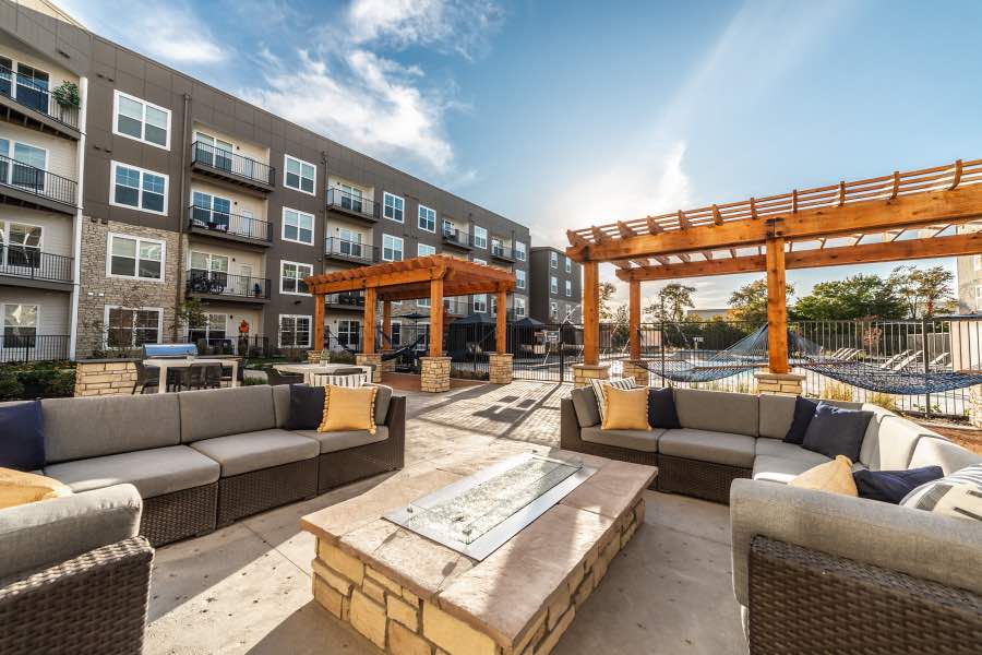 Outdoor seating with a fire table and pergolas