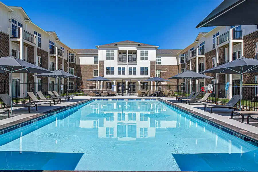 Not sure what a community means by amenities? This pool at Harmony Apartments is one example of an amenity. Pristine pool surrounded by apartment buildings at Harmony Apartments.